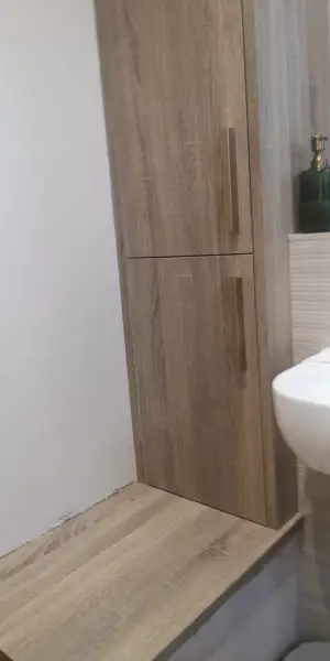 Laminated shower room cabinet Oak laminate and brushed brass handles: Swipe To View More Images